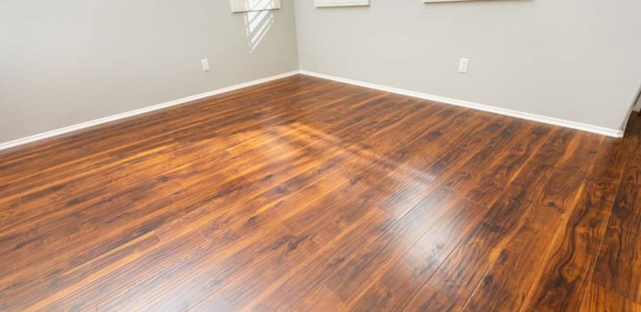 Newly Installed Brown Laminate Flooring and Baseboards in Home.