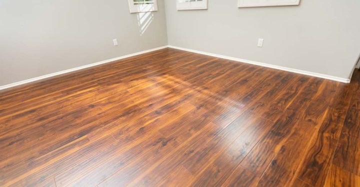 Newly Installed Brown Laminate Flooring and Baseboards in Home.