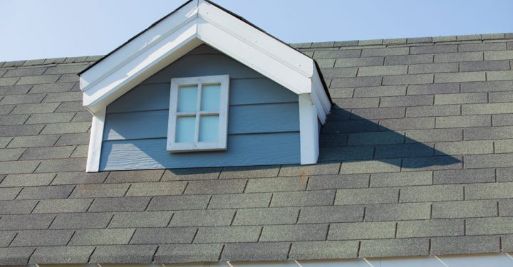 A house roof covered in asphalt shingle and a dormer gabled roof design